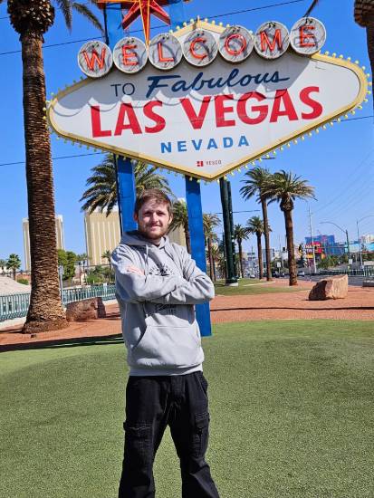 Ben Collazo in front of the “Welcome to Fabulous Las Vegas” sign