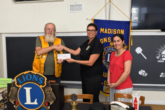 Tim Dunn presents the scholarship check to Traci McClung. Also photographed is Brienna Valentine.